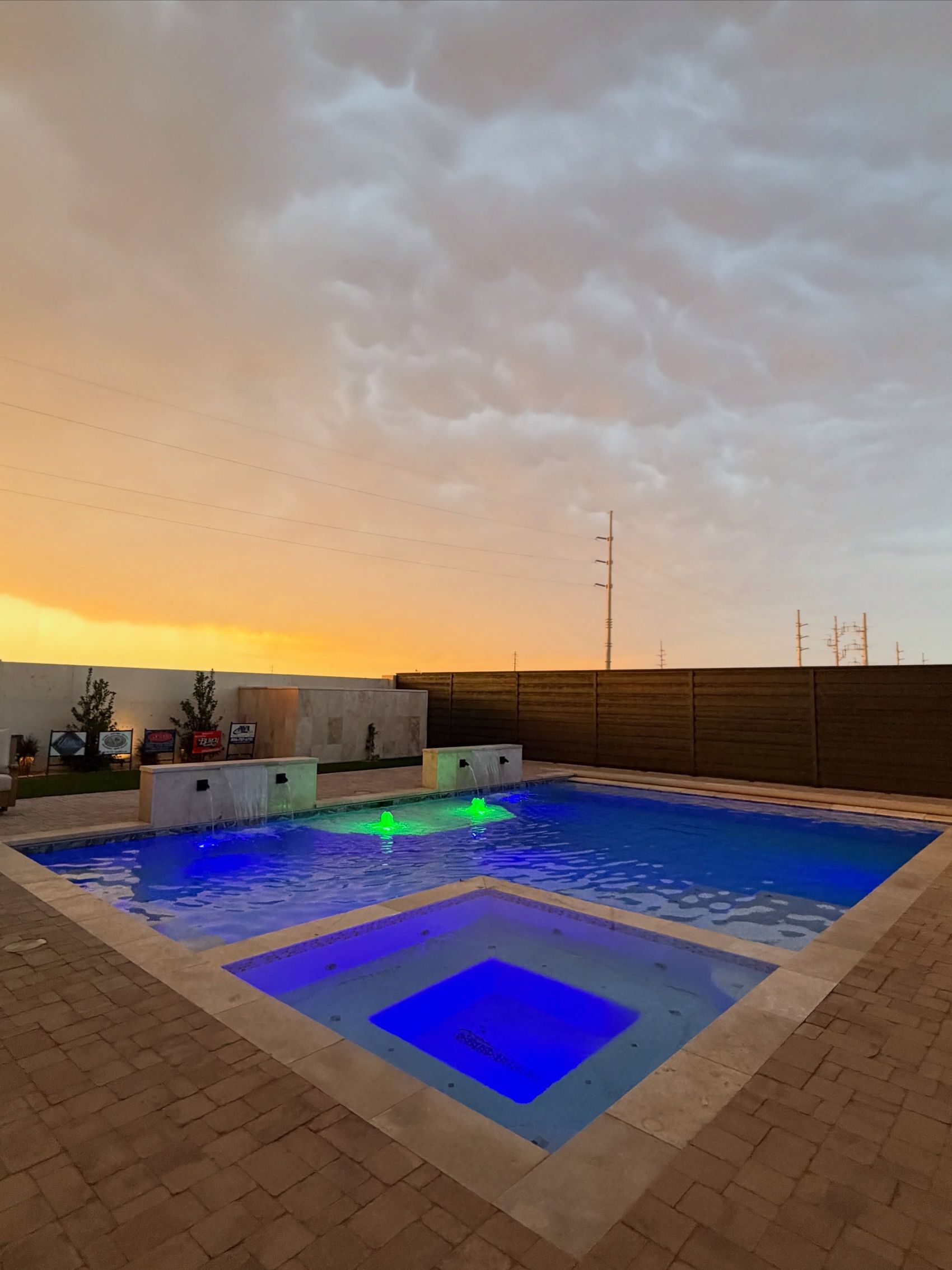 A luxury Lubbock backyard and pool under a West Texas sunset.